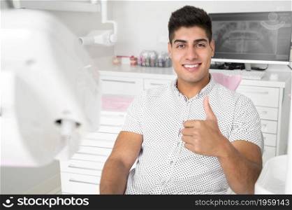 Man giving thumbs up at dentist office. High quality photo. Man giving thumbs up at dentist office