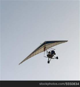 Man gliding in the sky at Mingsha Shan, Dunhuang, Jiuquan, Gansu Province, China