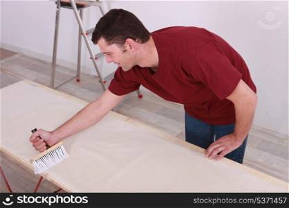 Man gluing paper