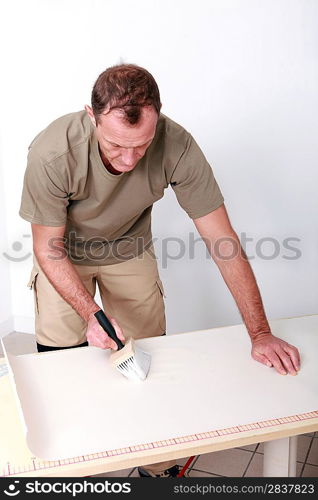 Man gluing wallpaper