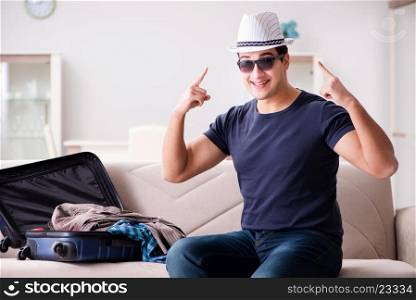 Man going on vacation packing his suitcase