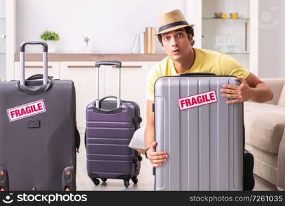 Man going on vacation with fragile suitcases