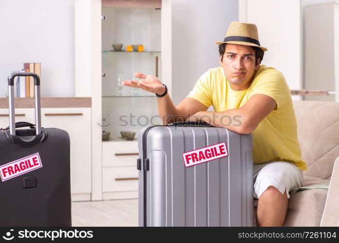 Man going on vacation with fragile suitcases