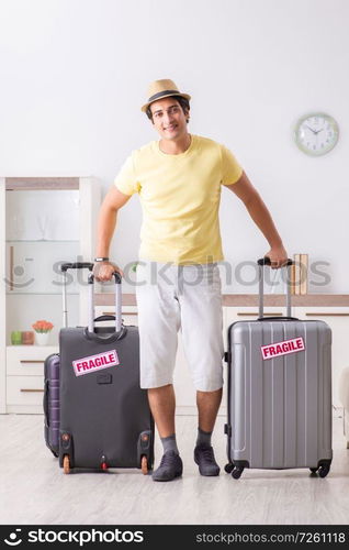 Man going on vacation with fragile suitcases