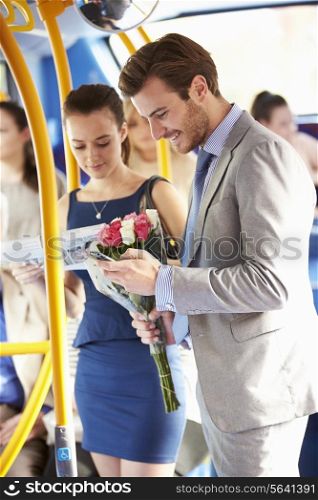 Man Going To Date On Bus Holding Bunch Of Flowers