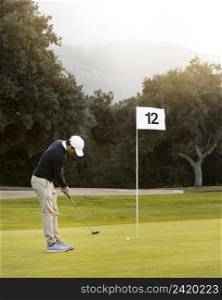 man golf field playing flag