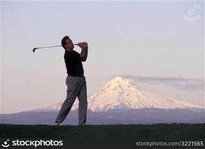 Man Golfing by Mount Hood