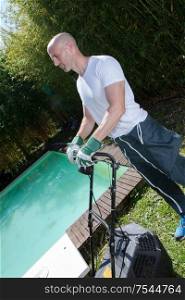 man grass cutting with lawn mower