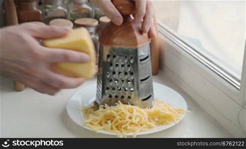 Man grating cheese for pizza