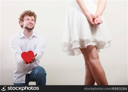 Man guy holding heart shaped present gift box for hot sexy woman girl. Valentine day love concept.. Man with heart shaped gift box for woman.