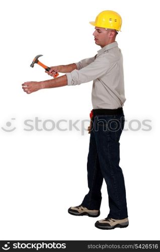 Man hammering an invisible object