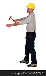 Man hammering an invisible object