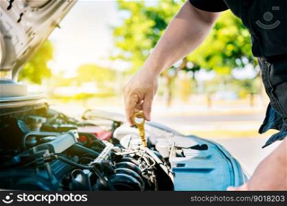 Man hand checking oil to car with copy space. People hand inspecting car oil level. Driver hand inspecting car oil level