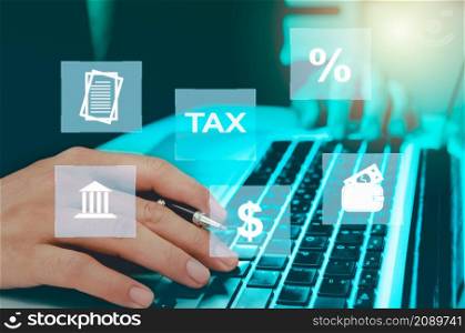 Man hand computer laptop virtual icon business tax. Business finance, investment and online tax payment. Technology concept on the Internet.