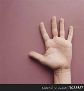 man hand gesturing on the pink wall, pink background