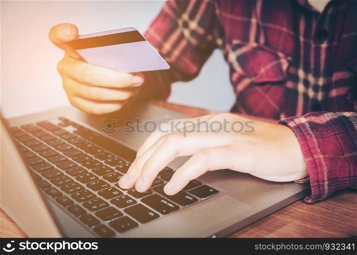 Man hand holding credit card using keyboard laptop online banking. shopping online