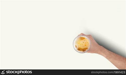 Man Hand Holding Mug Full Of Beer On White Background. Isolated top up view.