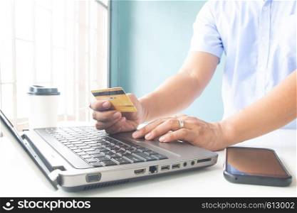 Man hand holding plastic credit card. E-payment, business and online payment