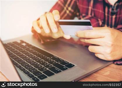 Man hand holding smartphone and credit card doing online banking. shopping online
