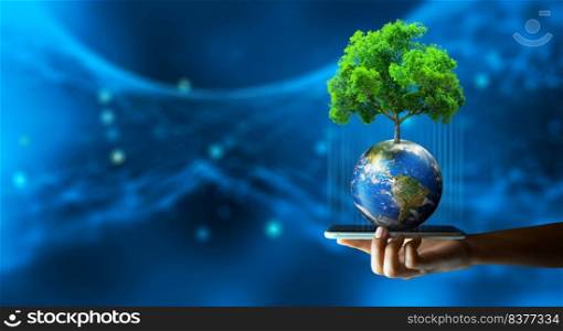 Man hand holding smartphone with Technology Economic. Tree growing on Earth and wireframe background. Green computing, Green IT, csr, and IT ethics Concept. Elements furnished by NASA.