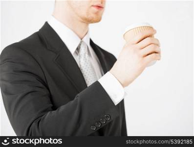 man hand holding take away coffee cup