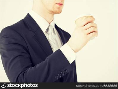 man hand holding take away coffee cup
