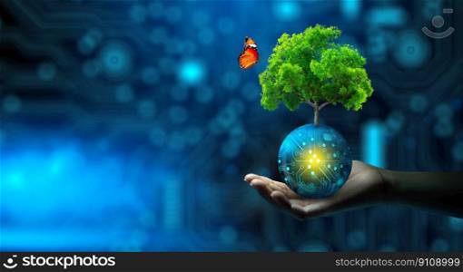 Man hand holding Tree on digital ball with technological convergence blue background. Green computing, csr, IT ethics, Nature technology interaction, and Environmental friendly.