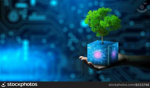 Man hand holding Tree on digital cube with technological convergence blue background. Green computing, csr, IT ethics, Nature technology interaction, and Environmental friendly.