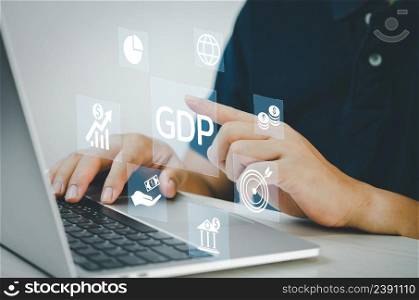 man hand using laptop to working technology and business concept.GDP Gross Domestic Product icons and symbols virtual screen.