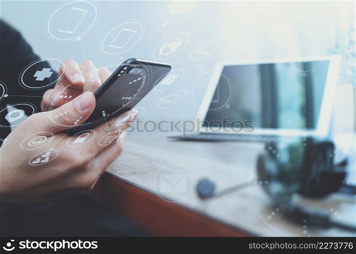man hand using VOIP headset with digital tablet computer docking keyboard,smart phone,concept communication, it support, call center and customer service help desk on wooden table,virtual interface icons screen