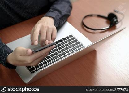 Man hand using VOIP headset with digital tablet computer docking smart keyboard, concept communication, it support, call center