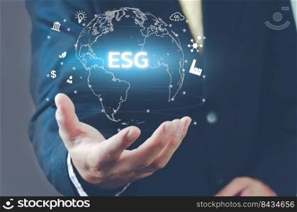 Man hand virtual world icon. ESG Environmental Social Governance icons and symbols virtual screen. Business concept.