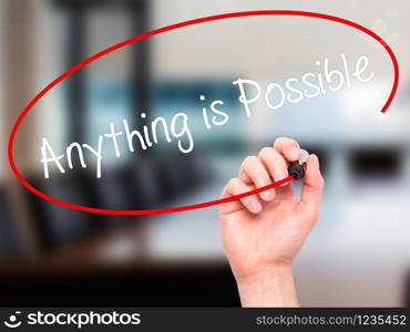 Man Hand writing Anything is Possible with black marker on visual screen. Isolated on office. Business, technology, internet concept. Stock Photo