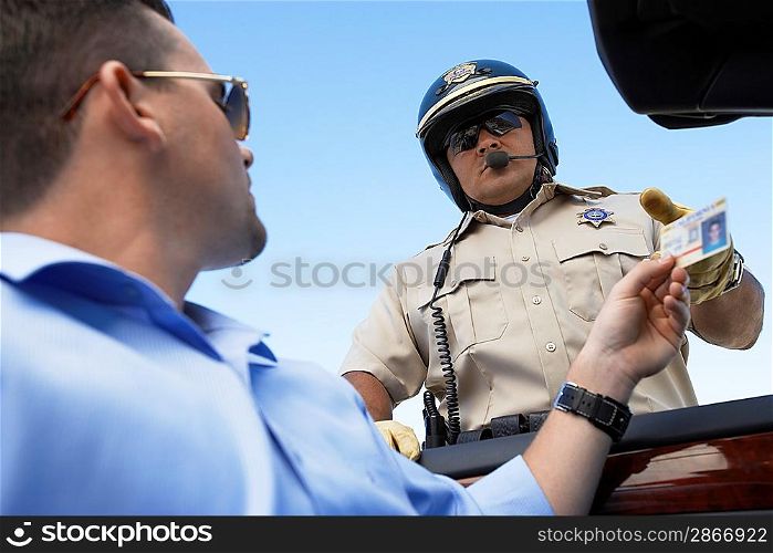 Man Handing a Police Officer her License