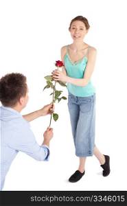 Man handing over a single red rose to a happy cheerful young woman isolated on white