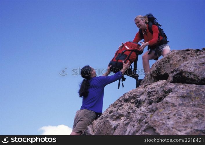 Man Handing Woman a Backpack