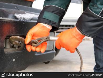 Man hands closeup with towing cable