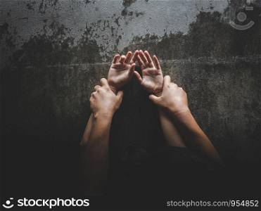 Man hands holding a woman hands for rape and sexual abuse concept.