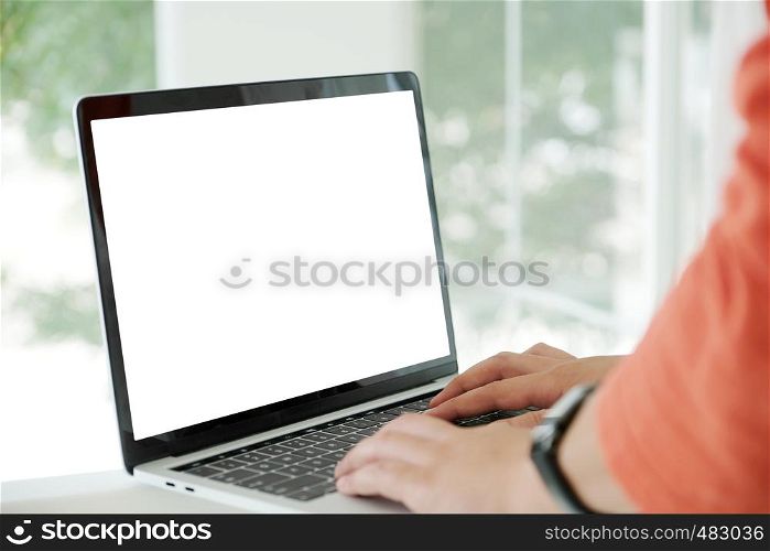 Man hands typing laptop computer with blank screen for mock up template background, business technology and lifestyle background concept
