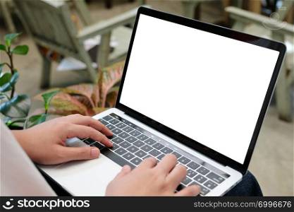 Man hands typing laptop computer with blank screen for mock up template background, business technology and lifestyle background concept