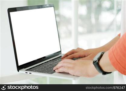 Man hands typing laptop computer with blank screen for mock up template background, top view, business technology and lifestyle background concept