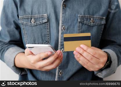 Man hands using smart phone and holding credit card, shopping online concept, mobile banking, business and technology