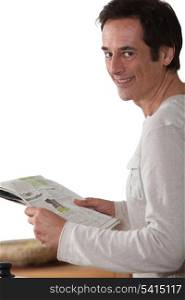 Man happy reading newspaper.