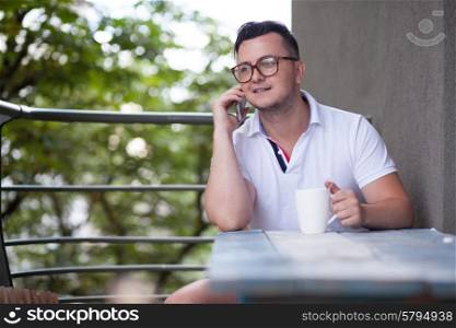 Man have phone conversation during coffee brake