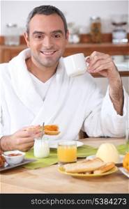 Man having breakfast in dressing gown