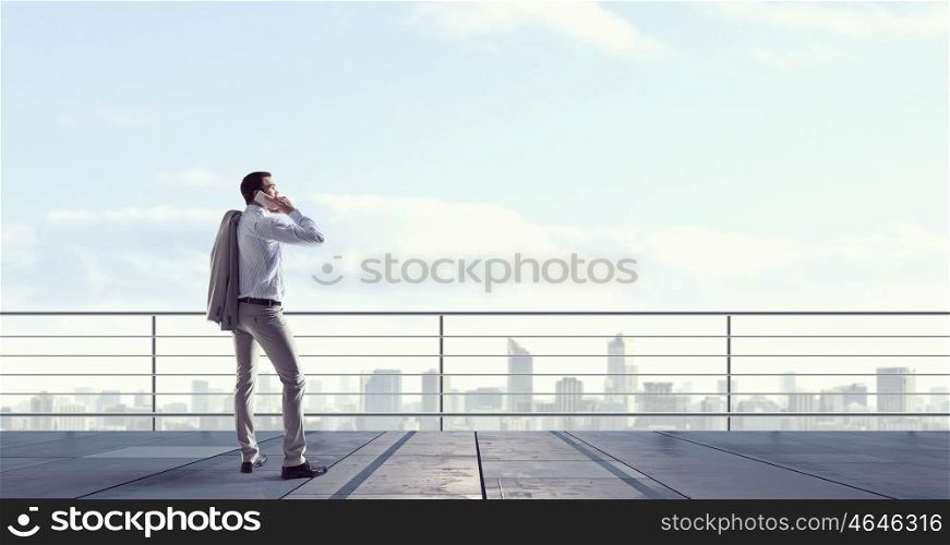 Man having business talk. Man boss having mobile phone conversation while standing on building top