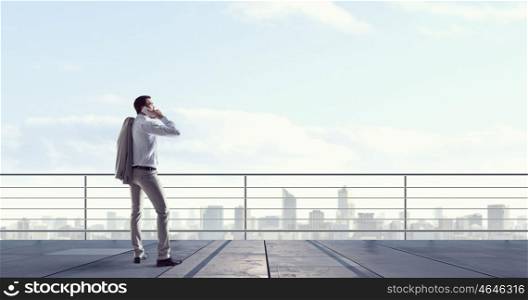 Man having business talk. Man boss having mobile phone conversation while standing on building top