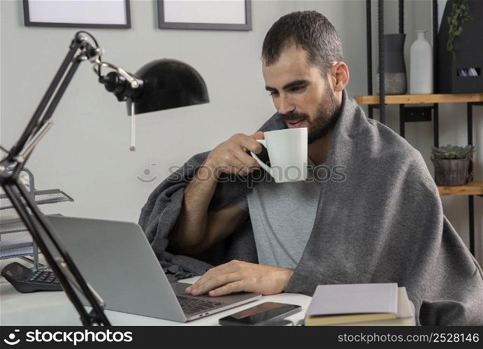 man having coffee while working from home