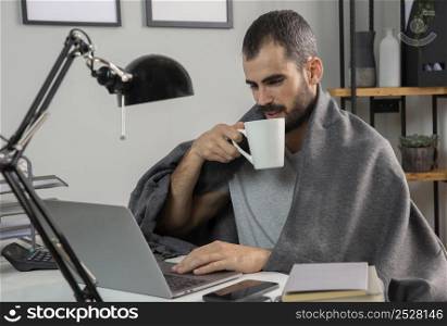 man having coffee while working from home