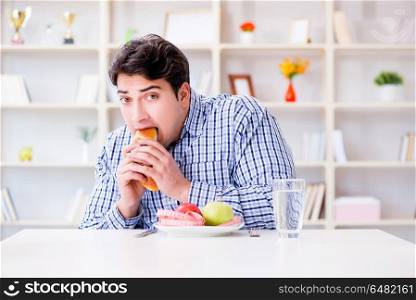 Man having dilemma between healthy food and bread in dieting con. Man having dilemma between healthy food and bread in dieting concept. Man having dilemma between healthy food and bread in dieting con